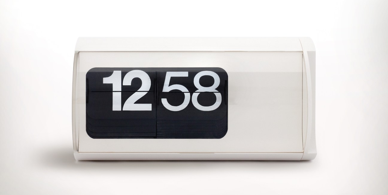 Solari Cifra 3 flip clock displaying 12:58 in white ABS plastic casing with black flap display.