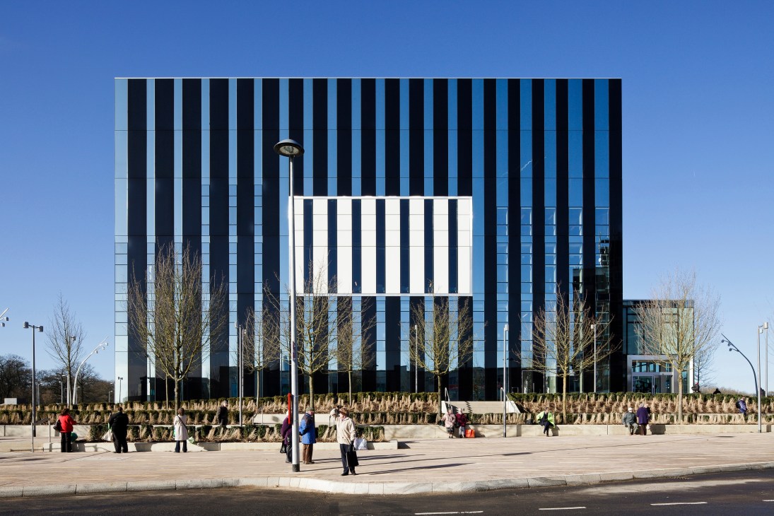 The Corby Cube civic centre with distinctive black and white striped barcode façade and public plaza.