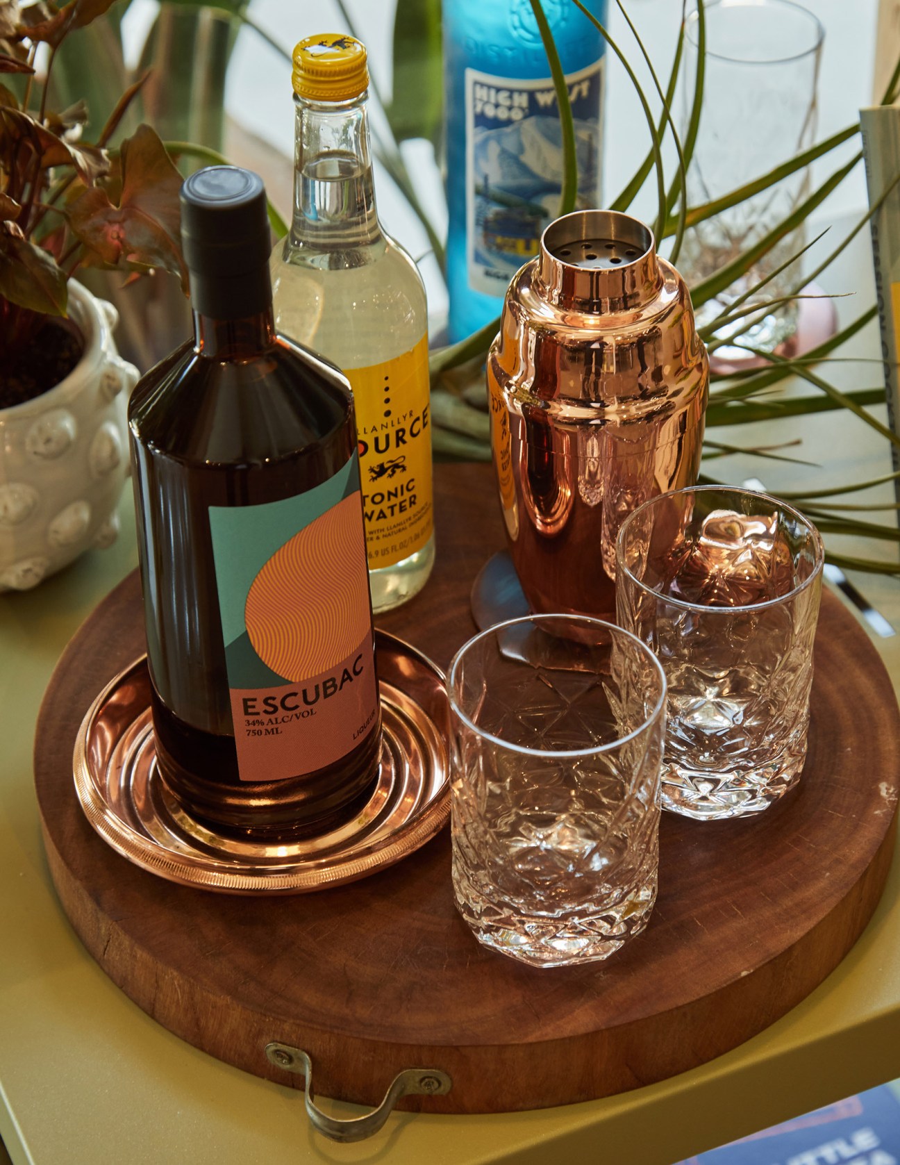 Flask & Field bar setup with Escubac bottle, tonic water, copper cocktail shaker and glasses with ice