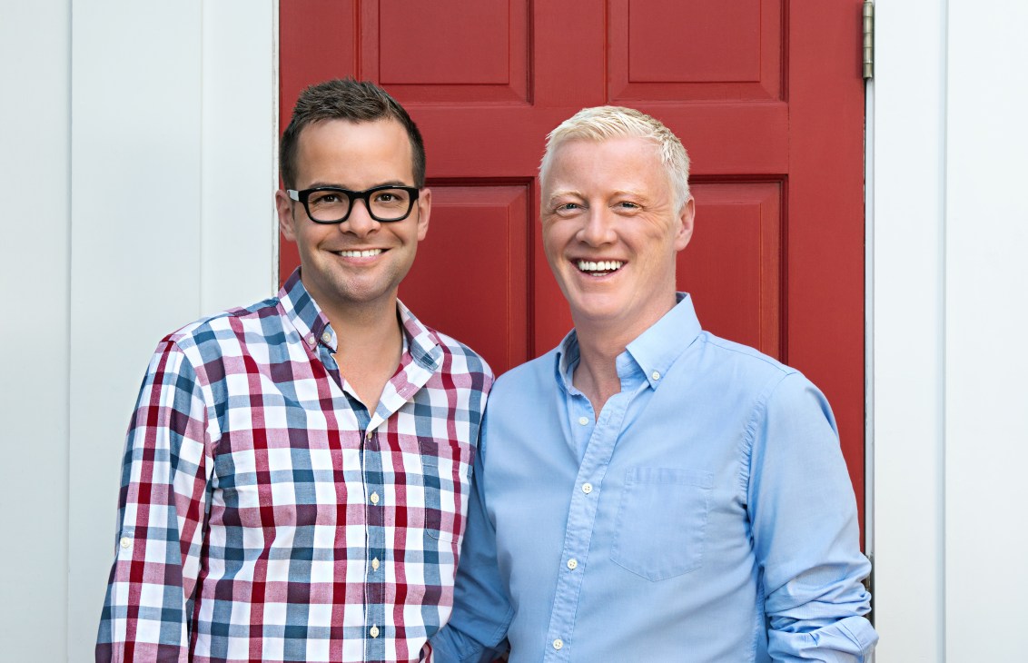 Kevin O'Shea and David Bowd, co-founders of Salt Hotels, pose together against a red door.