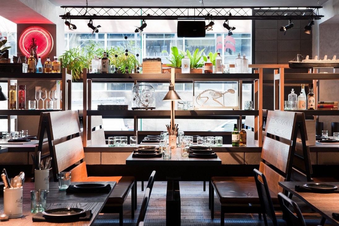 Modern bar interior with neon red tiger face sign, wooden furniture, and Asian-inspired cocktail menu at Claremont Tonic in Melbourne.