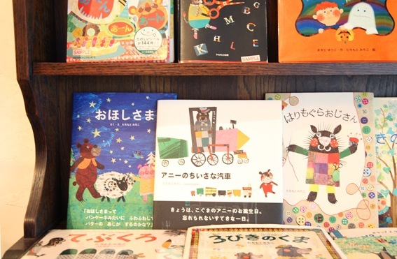 Shelves displaying children's books and illustrated materials by Japanese artist Michiko Tachimoto at Colobockle shop in Tokyo.