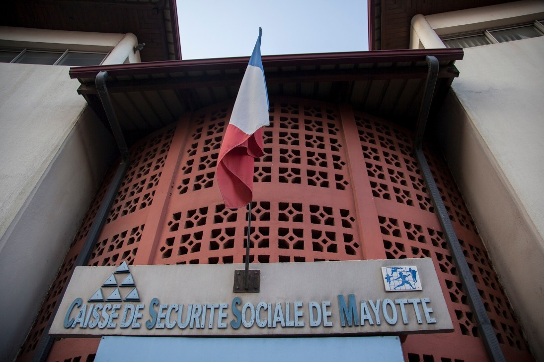 French flag flying above the entrance to the Caisse de Securite Sociale de Mayotte social security office building.