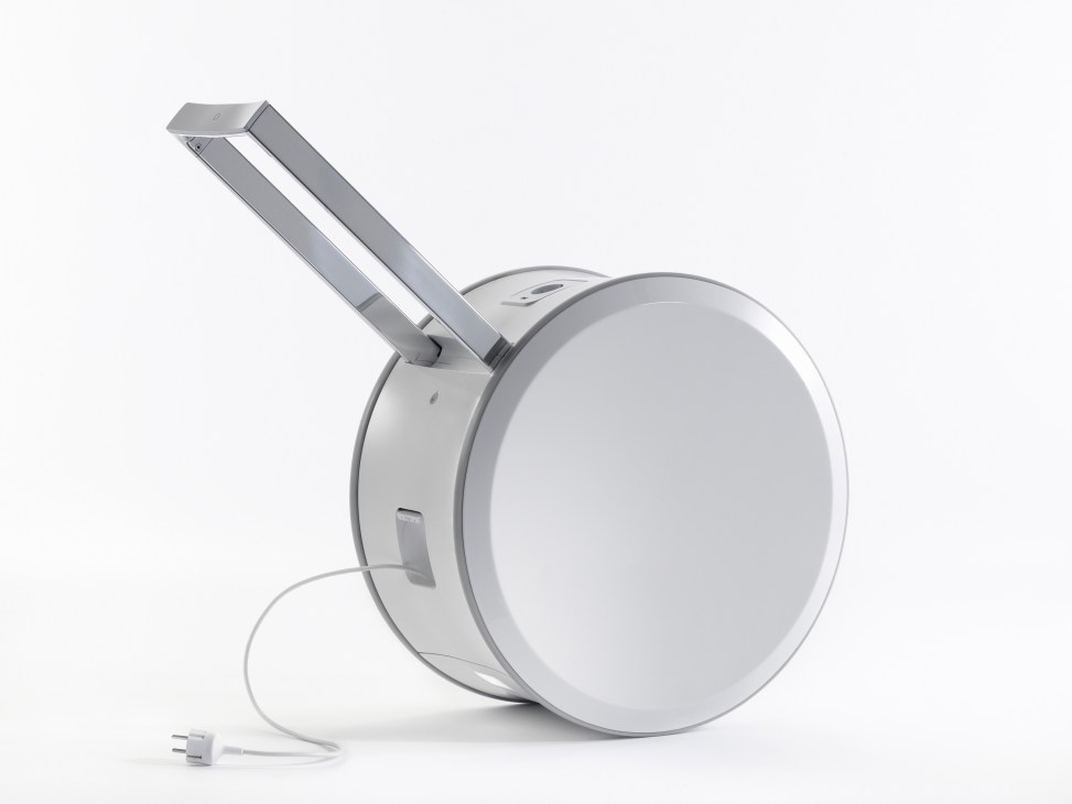 White cylindrical mobile energy storage unit with metal arm and power cord against white background.