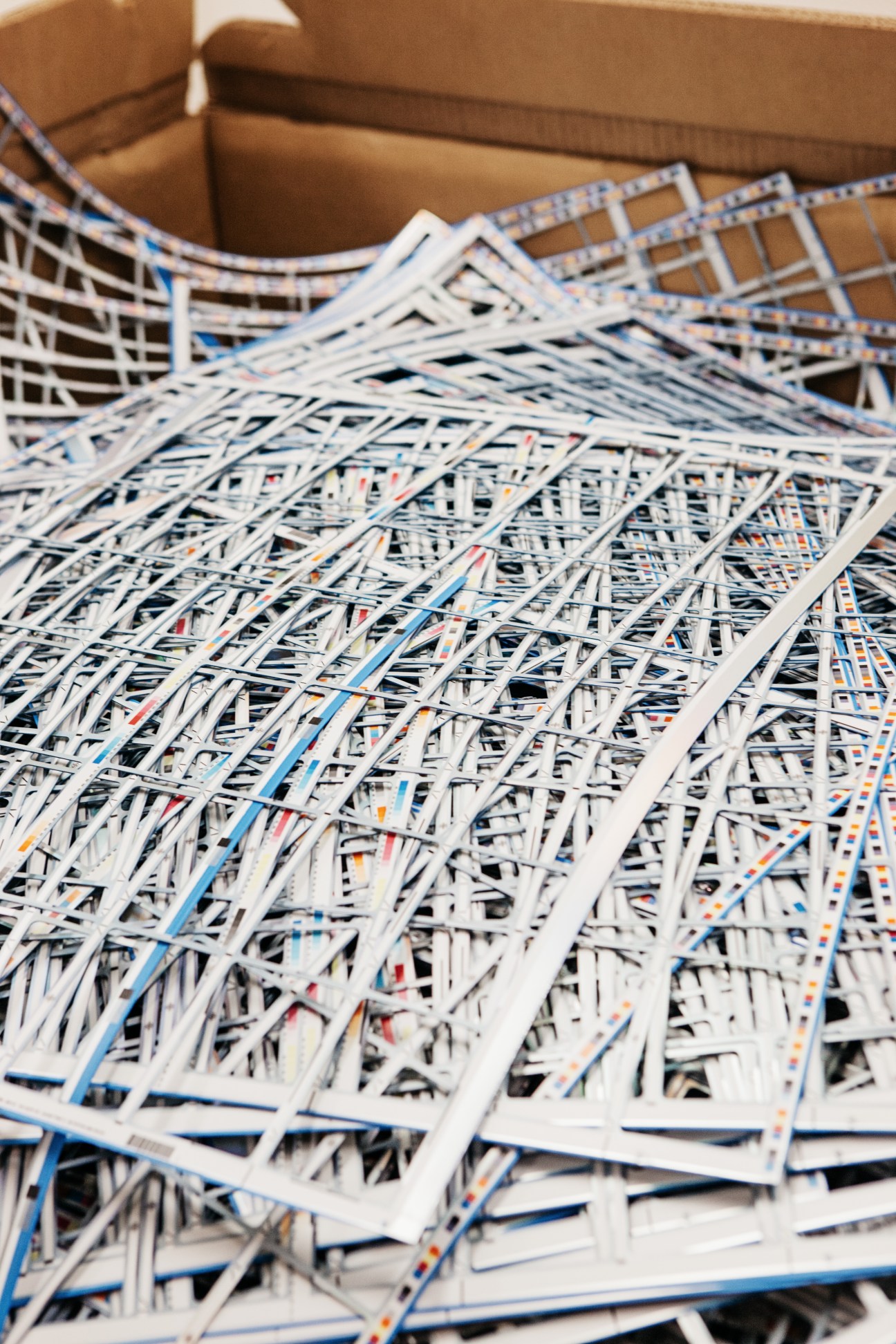 Shredded plastic strips in various colors ready for recycling at CPI Card Group manufacturing facility.