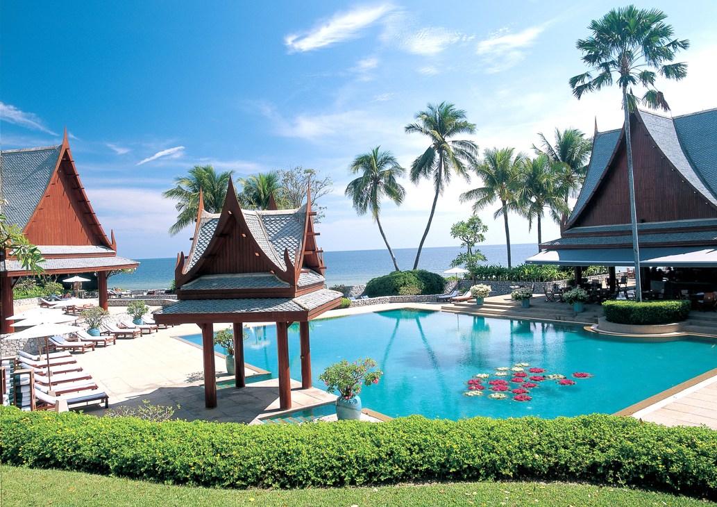 Tropical spa resort with Thai architecture, turquoise pool, palm trees and ocean views at Chiva-Som.