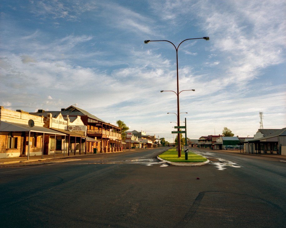 Empty street in the outback town of Cue with historic buildings under morning light.