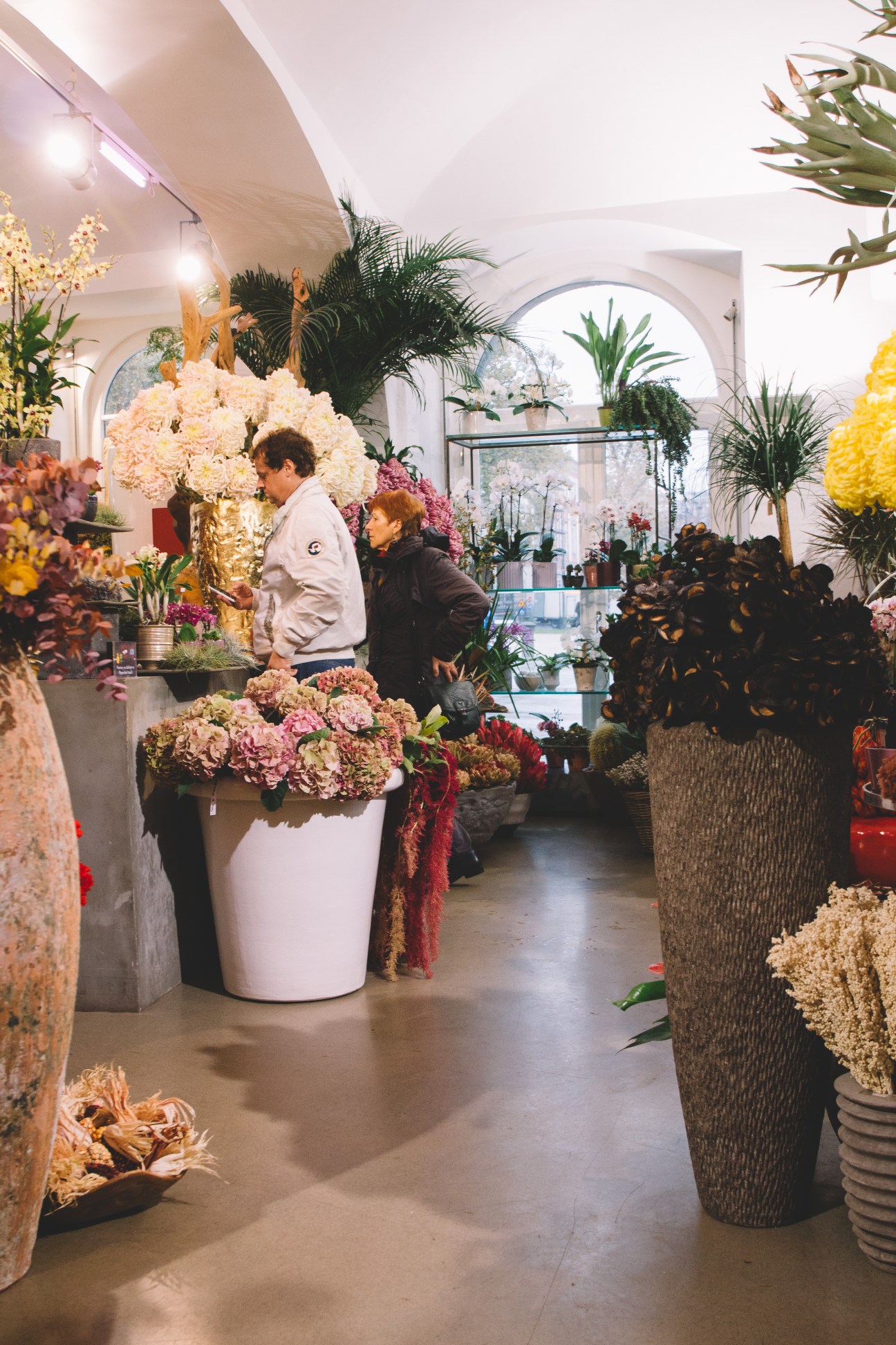 Customers browse flowers and tropical plants inside Cvetlicarna Emporia florist shop in Ljubljana.