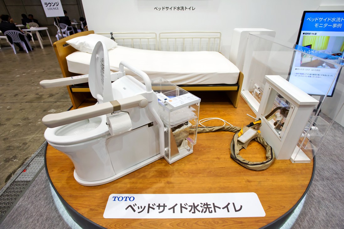 Toto's bedside toilet for hospitals displayed at Toilet Tokyo convention with integrated bidet seat.