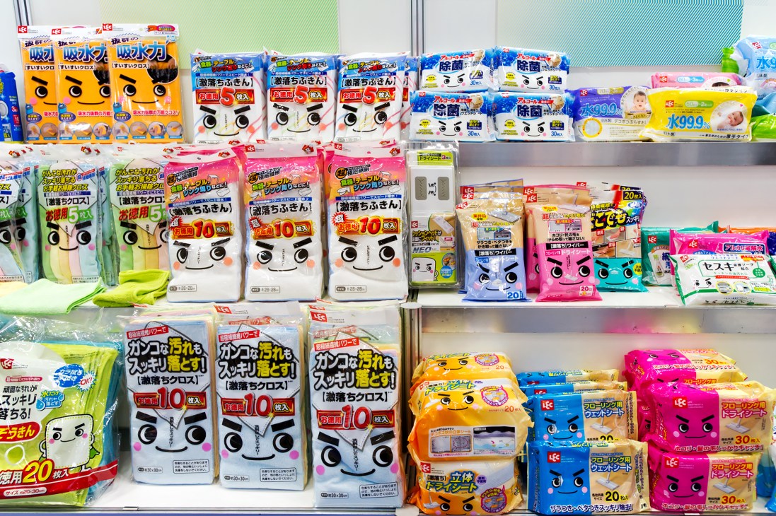 Shelves displaying colorful packaged toilet-cleaning products with Japanese branding and mascot characters.