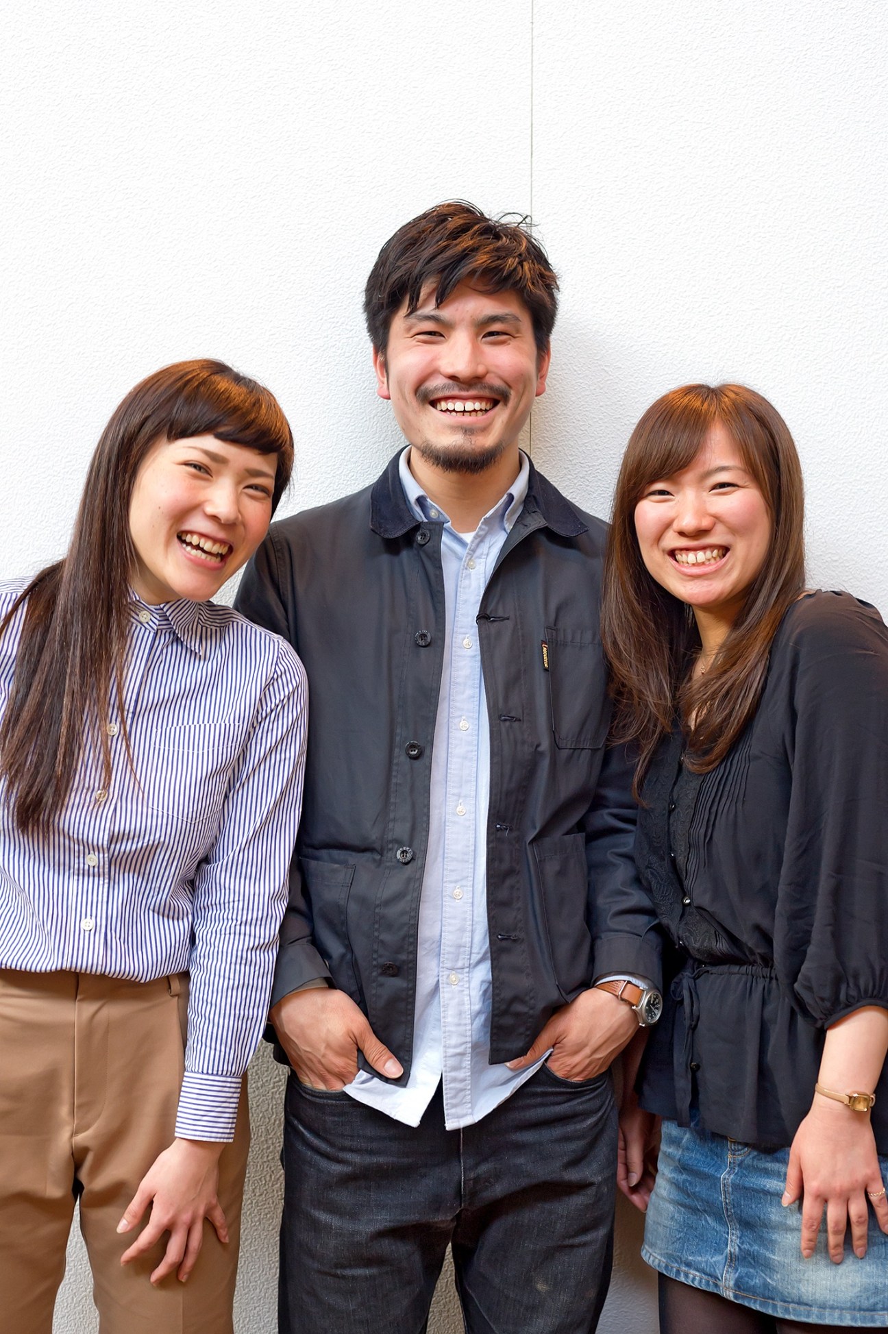 Three smiling Glen Clyde staff members pose together against a white wall.