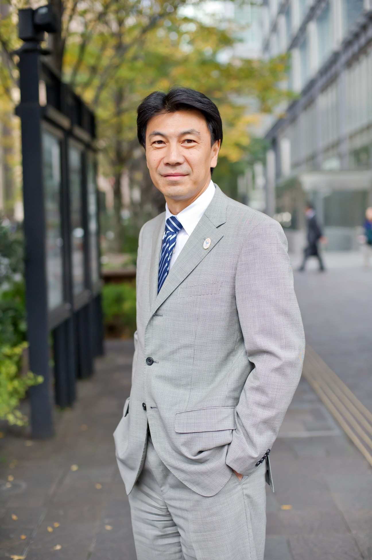 Takashi Kobari, head of Mitsubishi Estate's urban-development promotion department, poses on a Tokyo street.