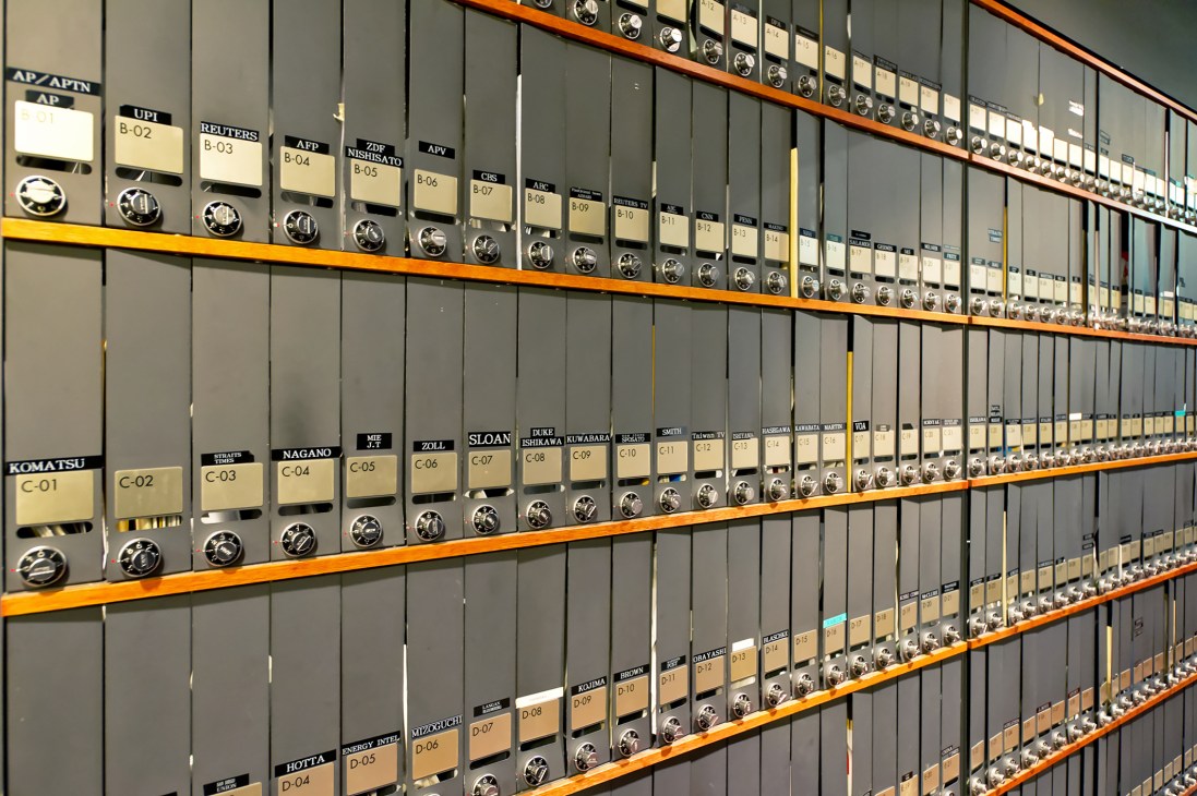 Wall of numbered mailboxes with name labels for Foreign Correspondents' Club members.