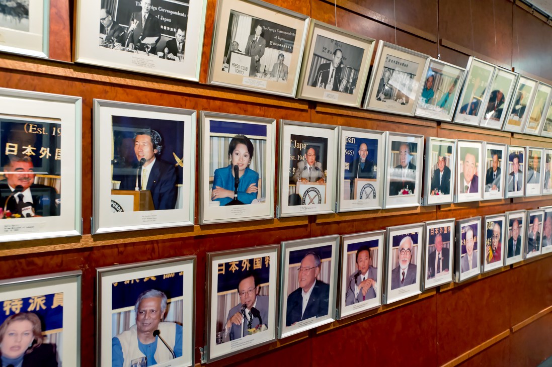 Wall display of framed photographs showing illustrious speakers at the Foreign Correspondents' Club of Japan.