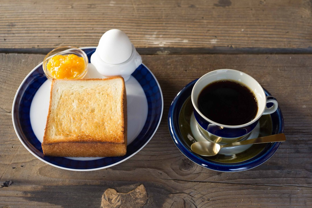 Toast with jam and a cup of black coffee on blue and white plates at Mimet, Tokyo.