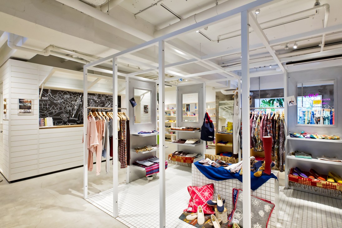 Interior of Nohara fitness studio in Tokyo with white framework, clothing displays, and modern retail design.