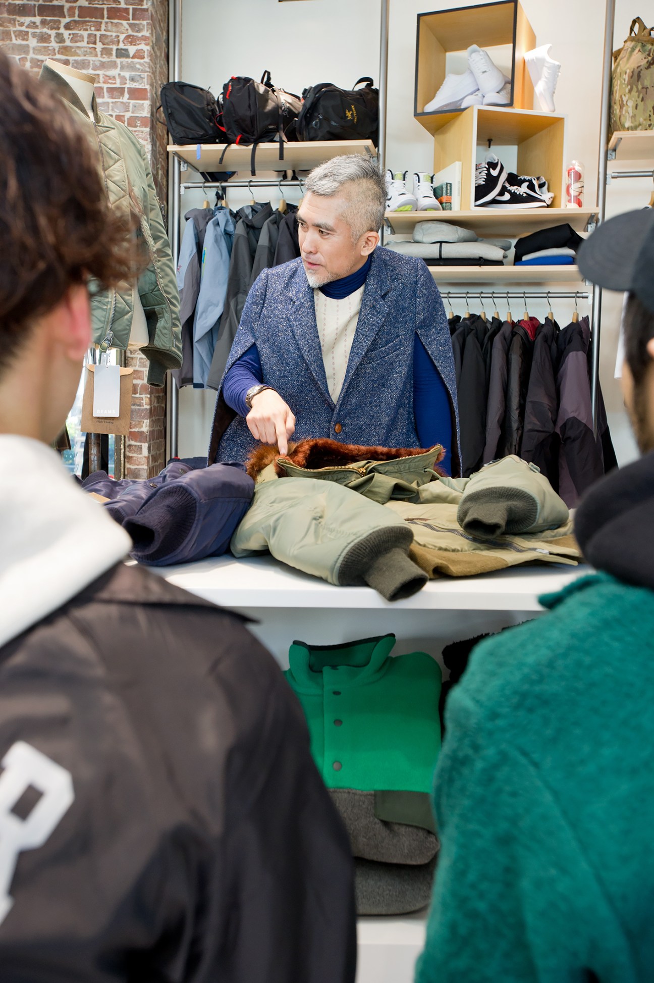Kenjiro Wada demonstrates a vintage aviation jacket to Beams staff during a styling seminar.