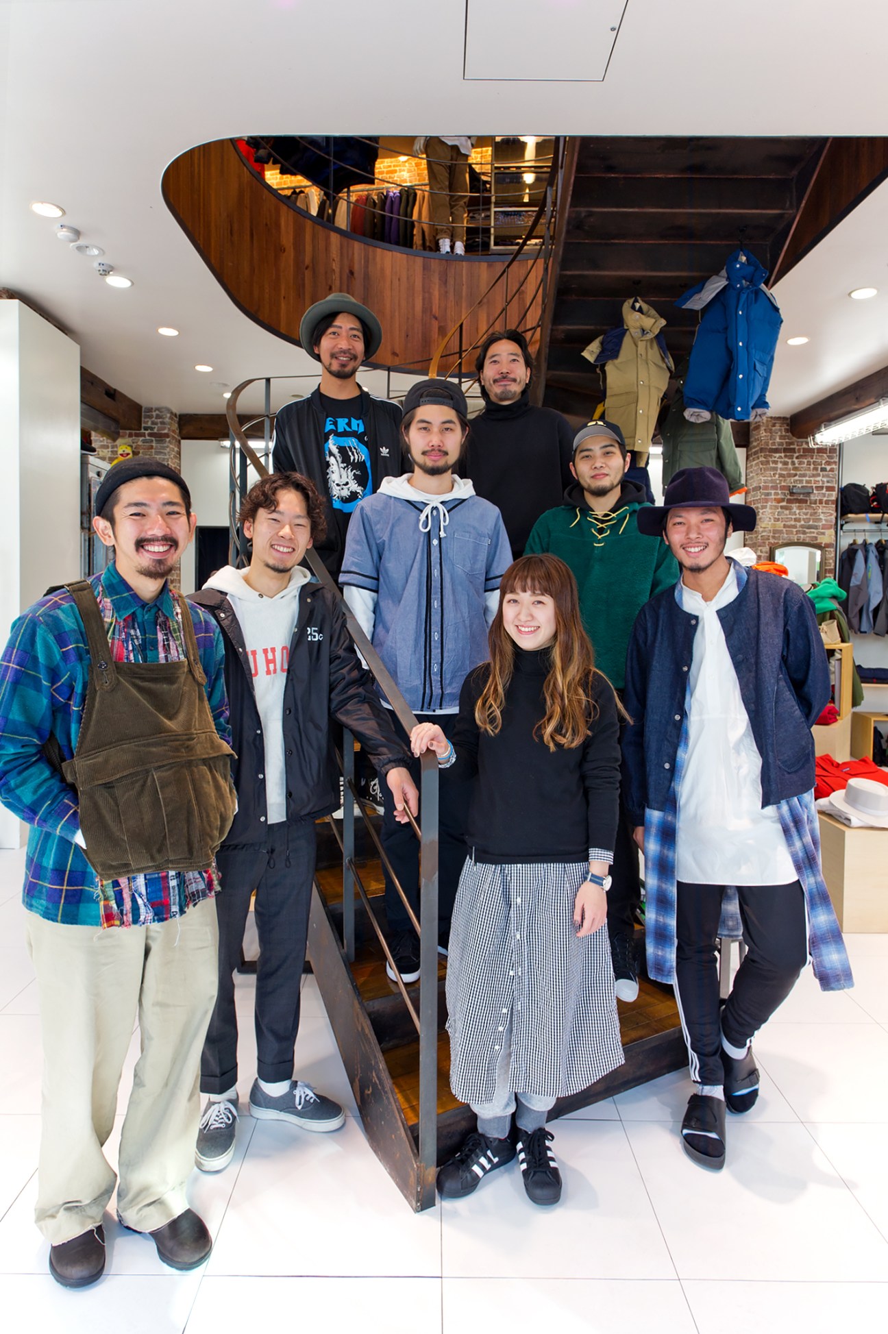 Beams Harajuku shop staff pose together in the store wearing stylish, coordinated outfits.