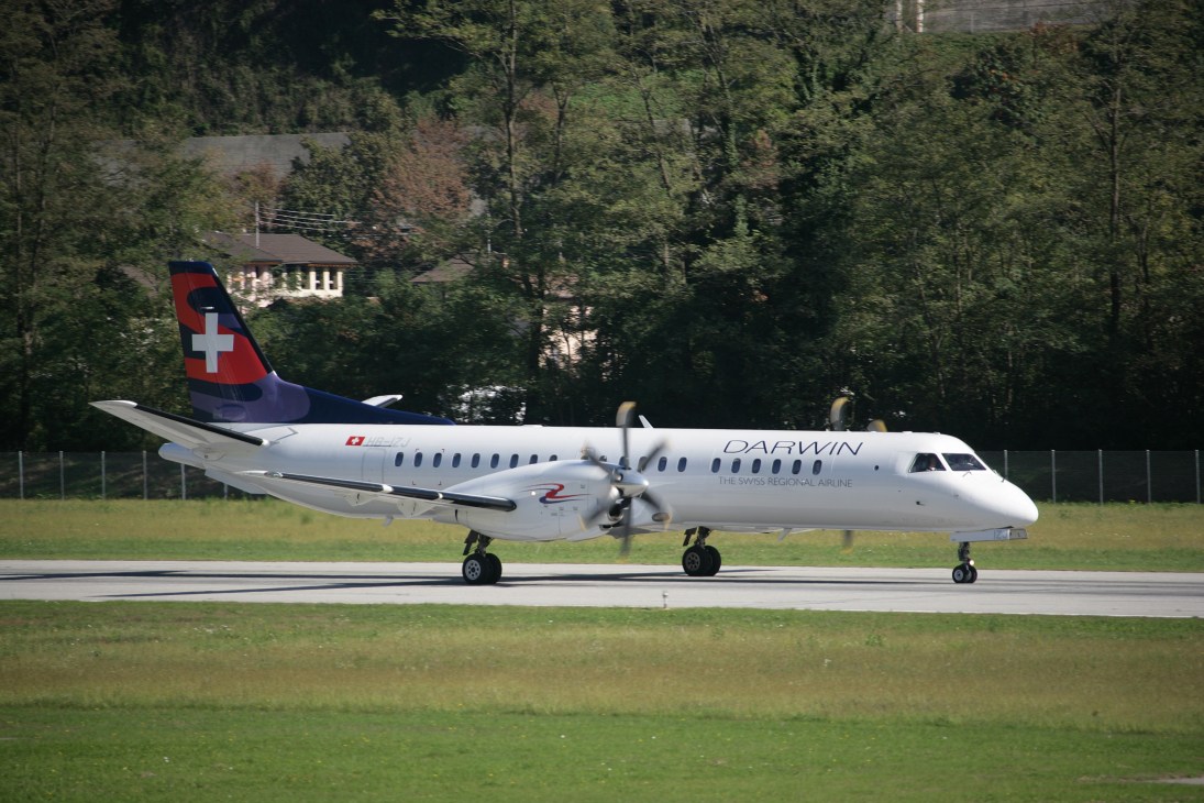 Darwin Airline SAAB 2000 Turbo aircraft with Swiss flag on tail at airport runway.