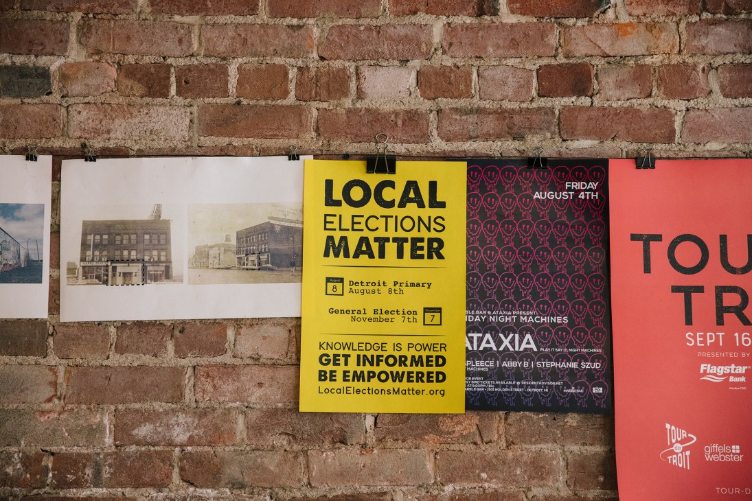 Election leaflets pinned to a brick wall including a yellow "Local Elections Matter" poster.