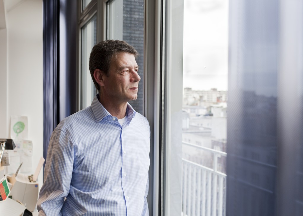 Christoph Lanz, global director of Deutsche Welle, looking out a window in an office.