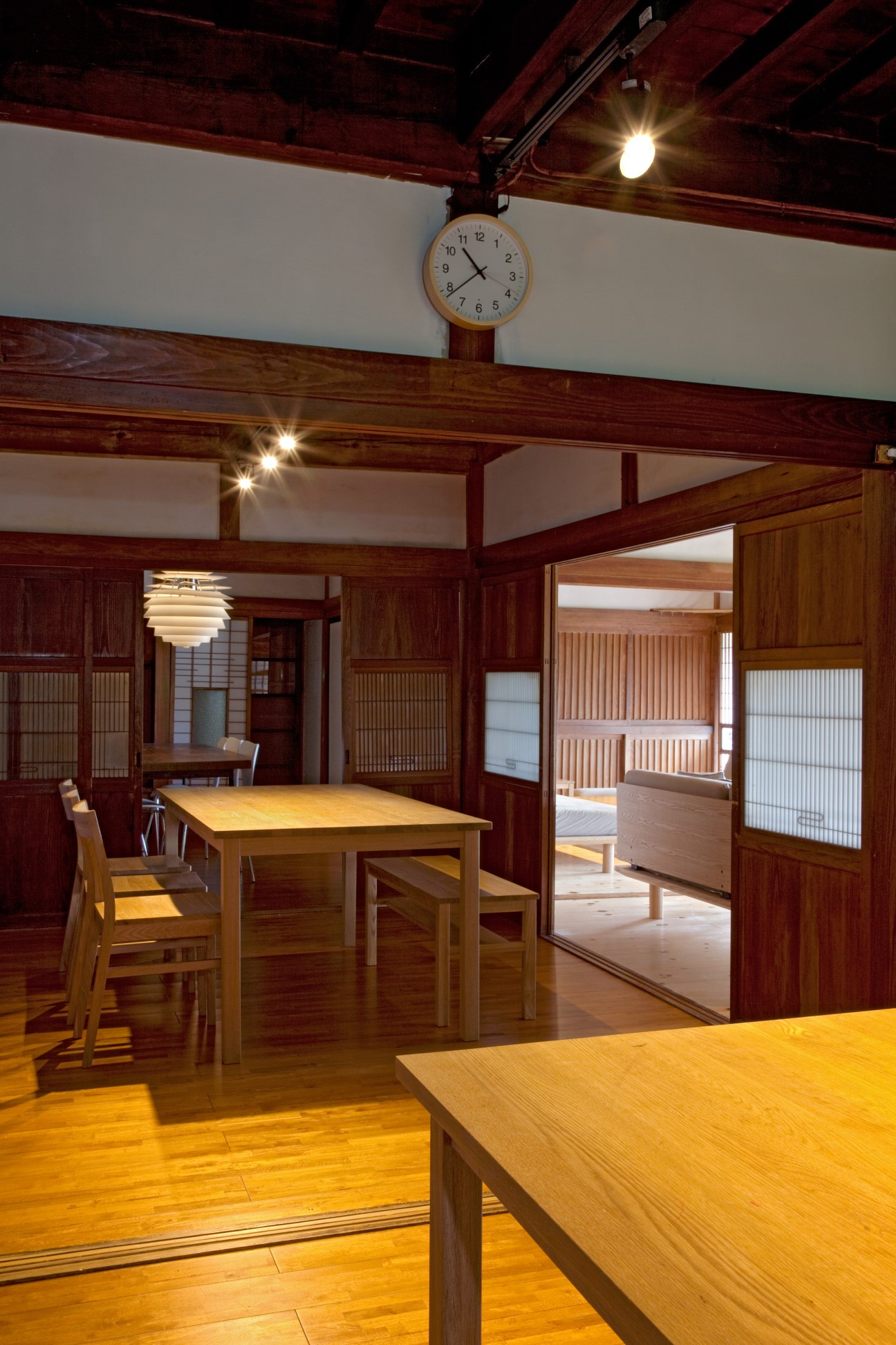 Wooden dining room with wooden table, chairs, hinoki cypress beams, and traditional Japanese architectural elements.
