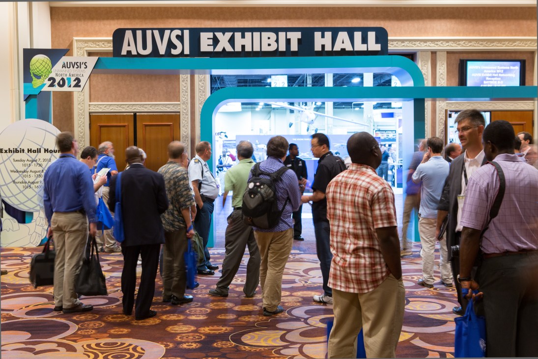 Visitors gather at the entrance to the AUVSI Exhibit Hall at the 2012 Unmanned Systems North America trade fair.