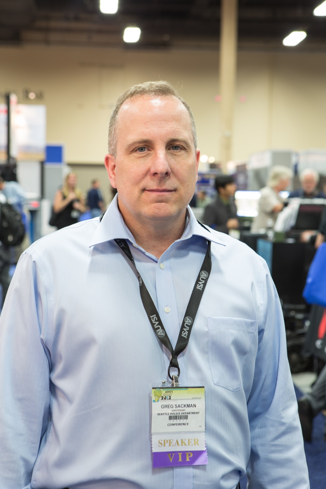 Lt Greg Sackman from Seattle Police Department wearing a speaker badge at the trade fair.