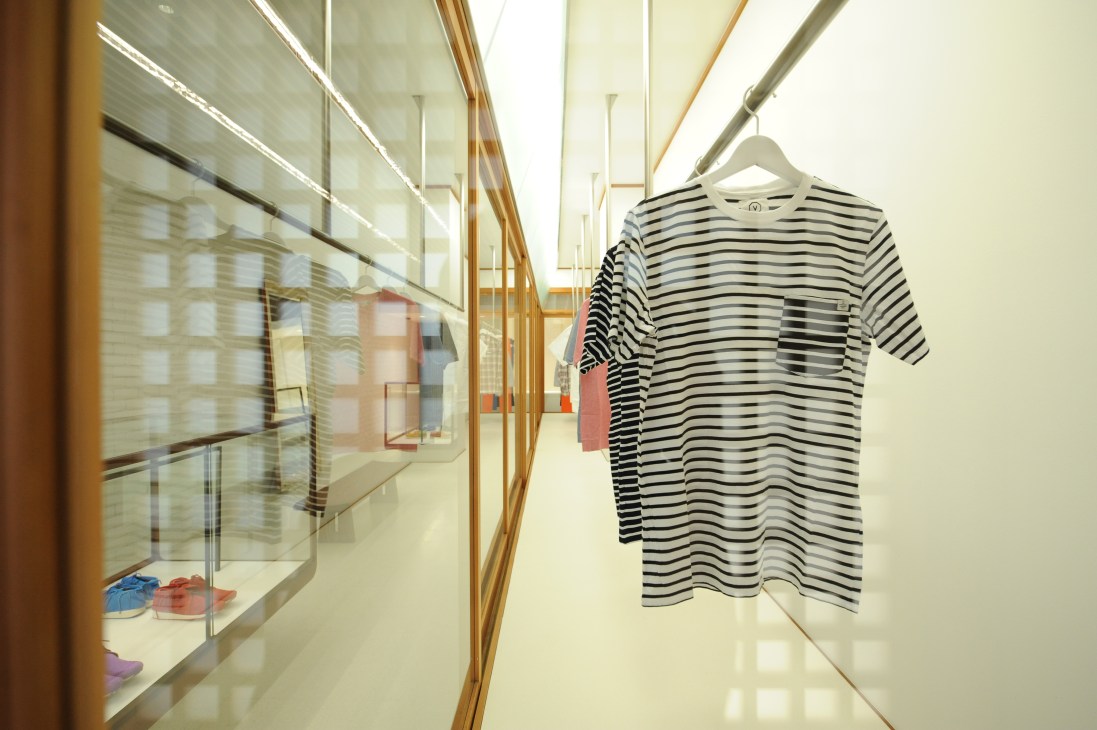 Interior of Visvim's Free International Laboratory retail store in Tokyo displaying striped t-shirt on hanger.