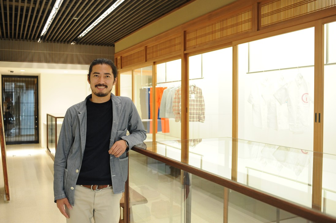 Hiroki Nakamura, founder of Visvim fashion brand, standing in his Tokyo retail space.