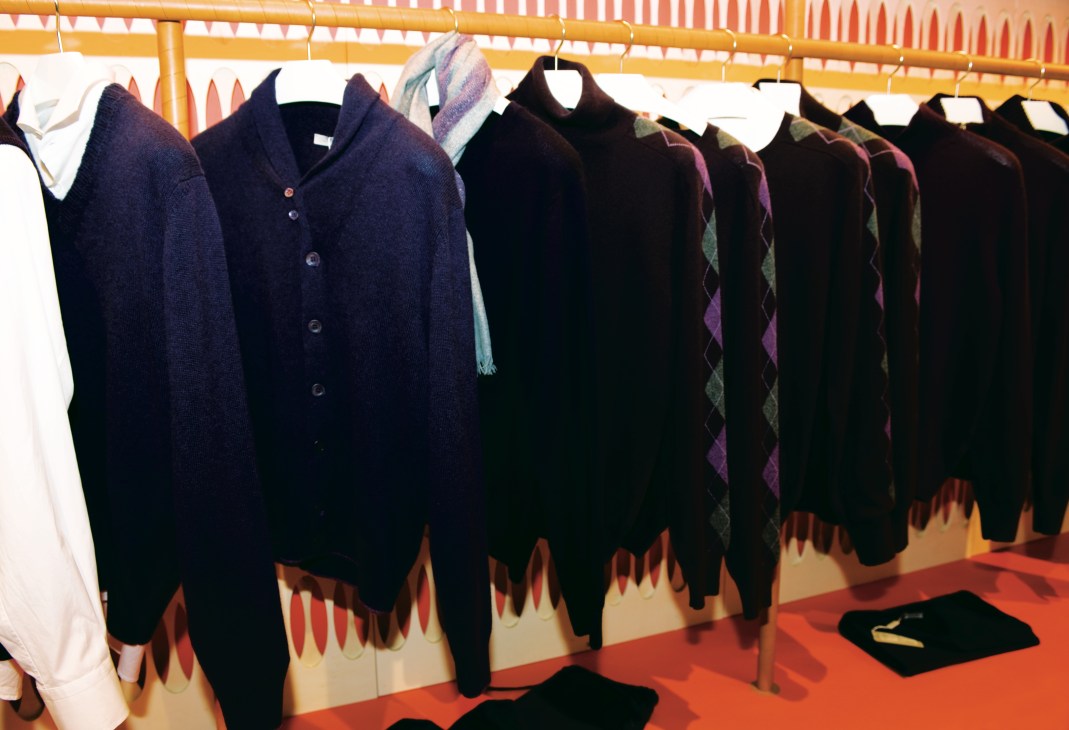 Cruciani cashmere sweaters and cardigans displayed on hangers at Pitti Uomo trade show