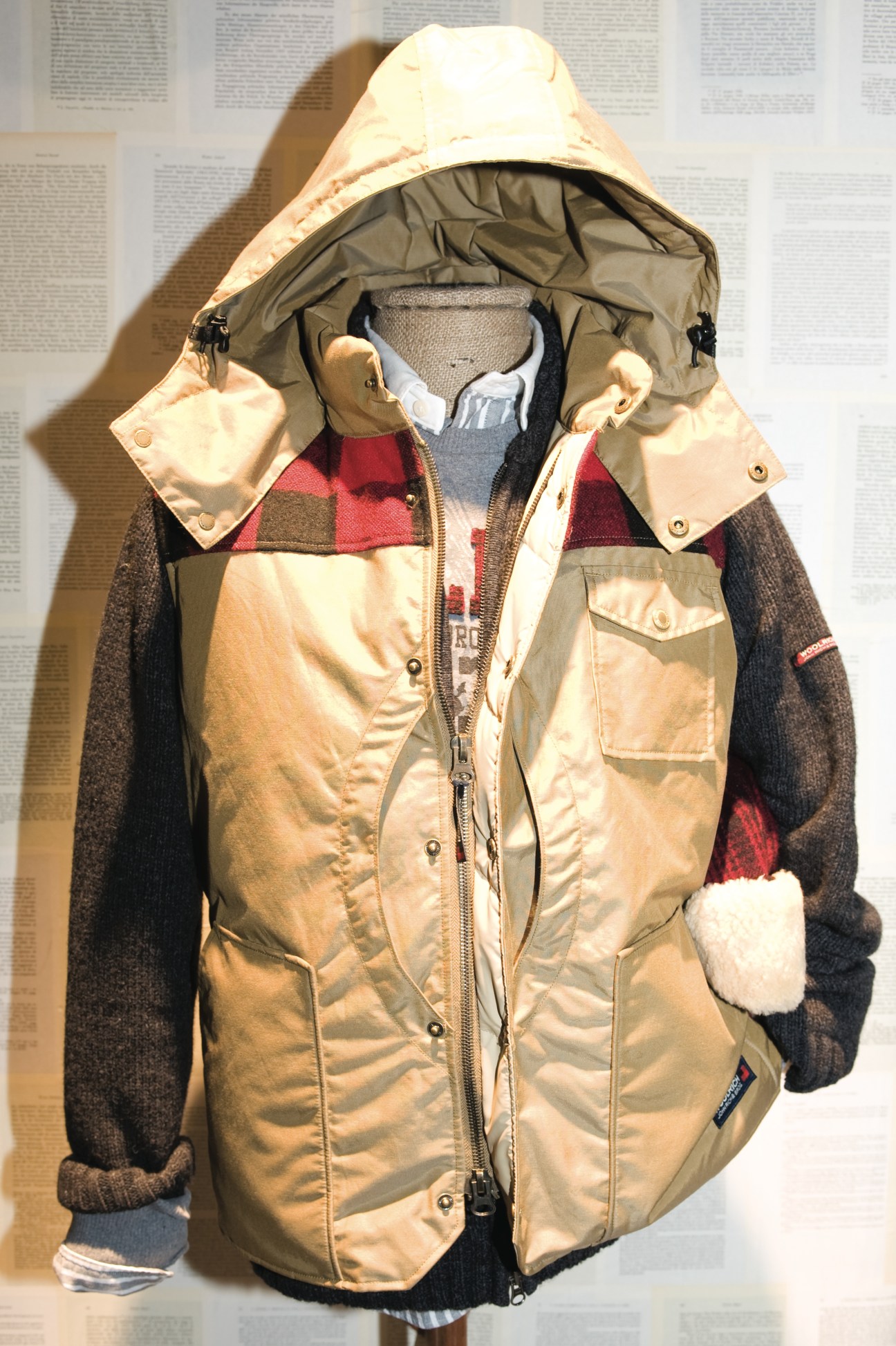 Woolrich padded jacket with detachable hood displayed on a mannequin wearing layered clothing.