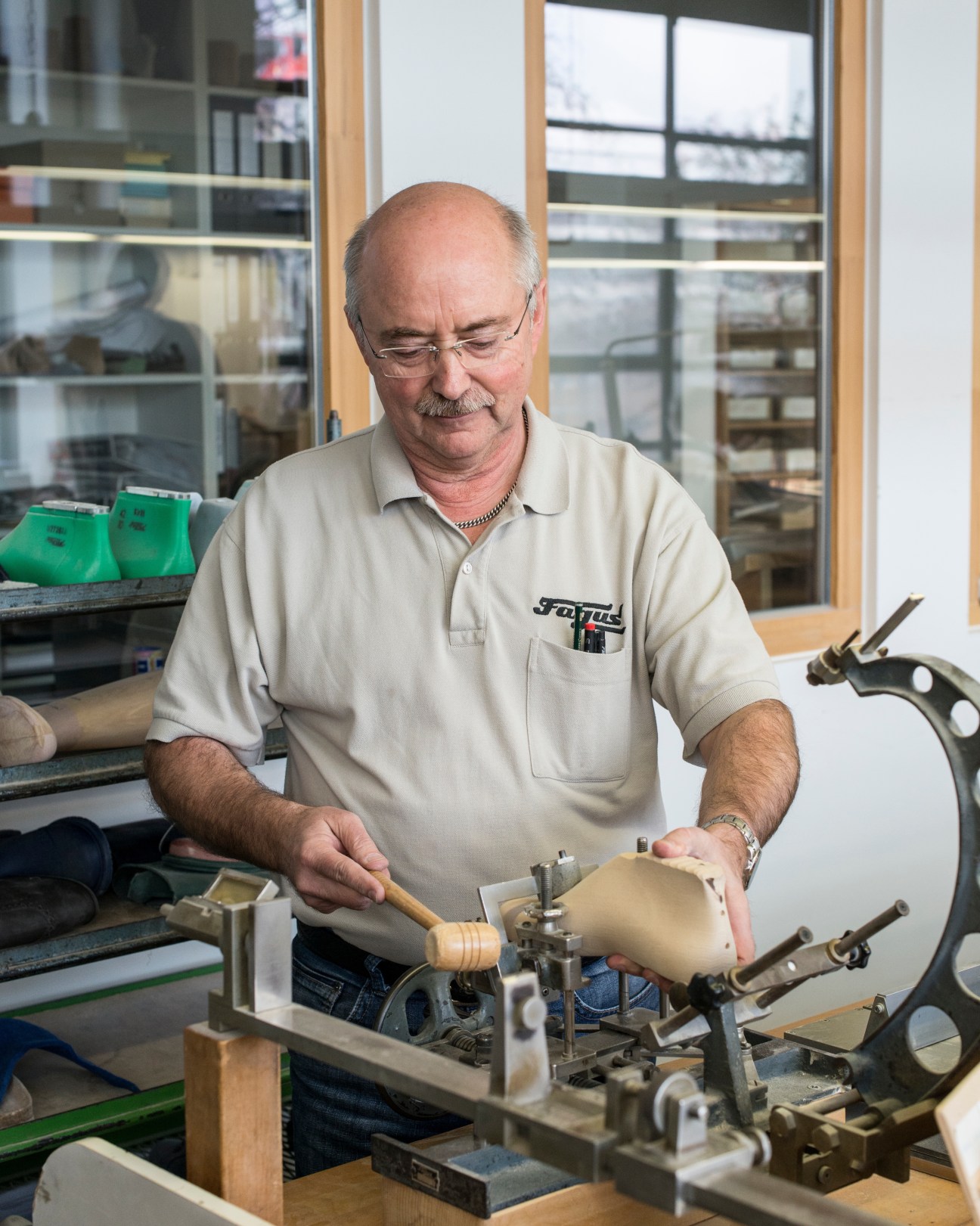 Bernd Lange works on a wooden shoe last at his workbench at Fagus-GreCon factory.
