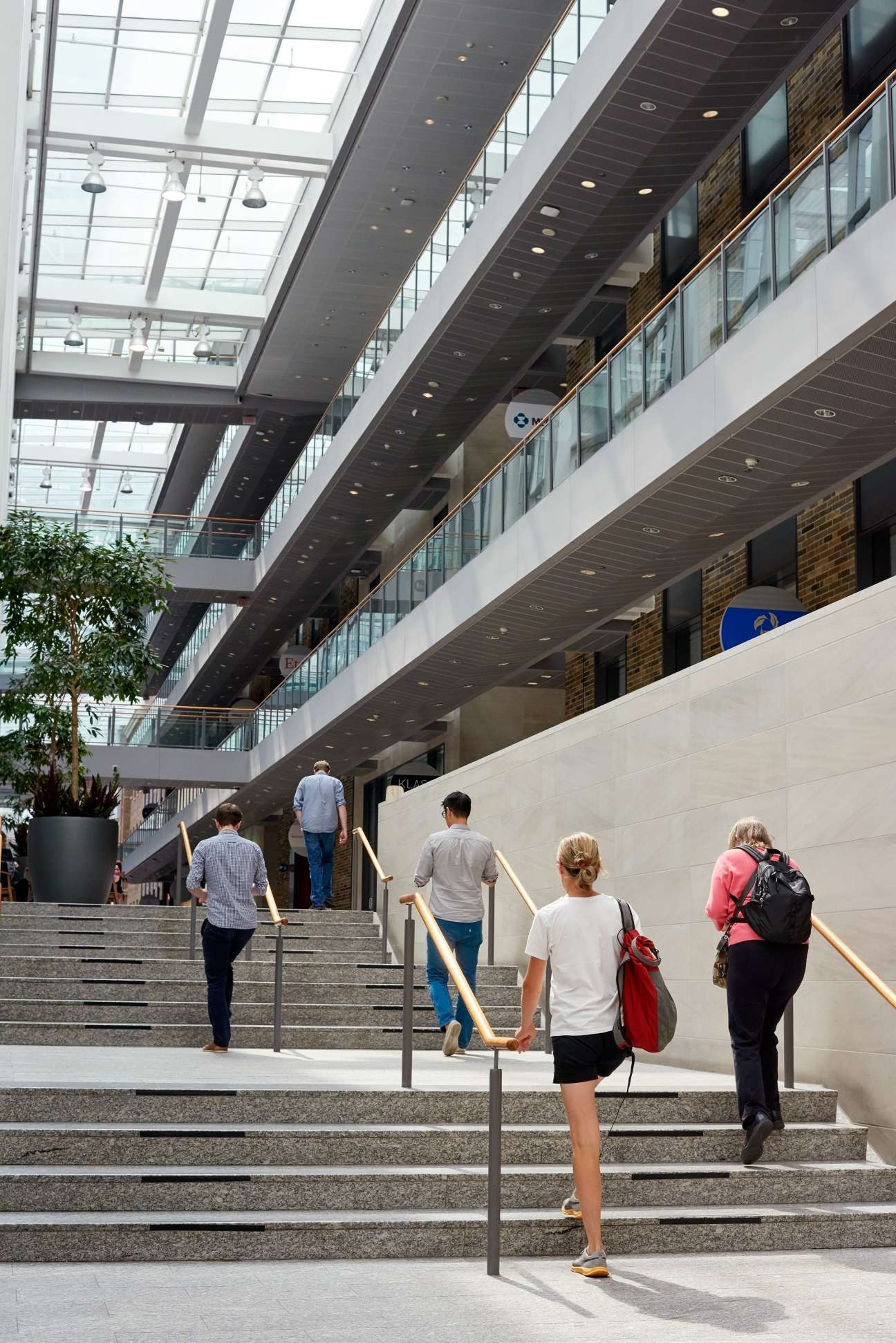 Interior of Mars Discovery District with multiple levels, skylights, and people on stairs.