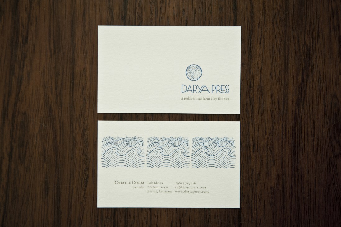 Darya Press business cards featuring sea-wave logo and founder Carole Corm's contact information on cream cardstock.