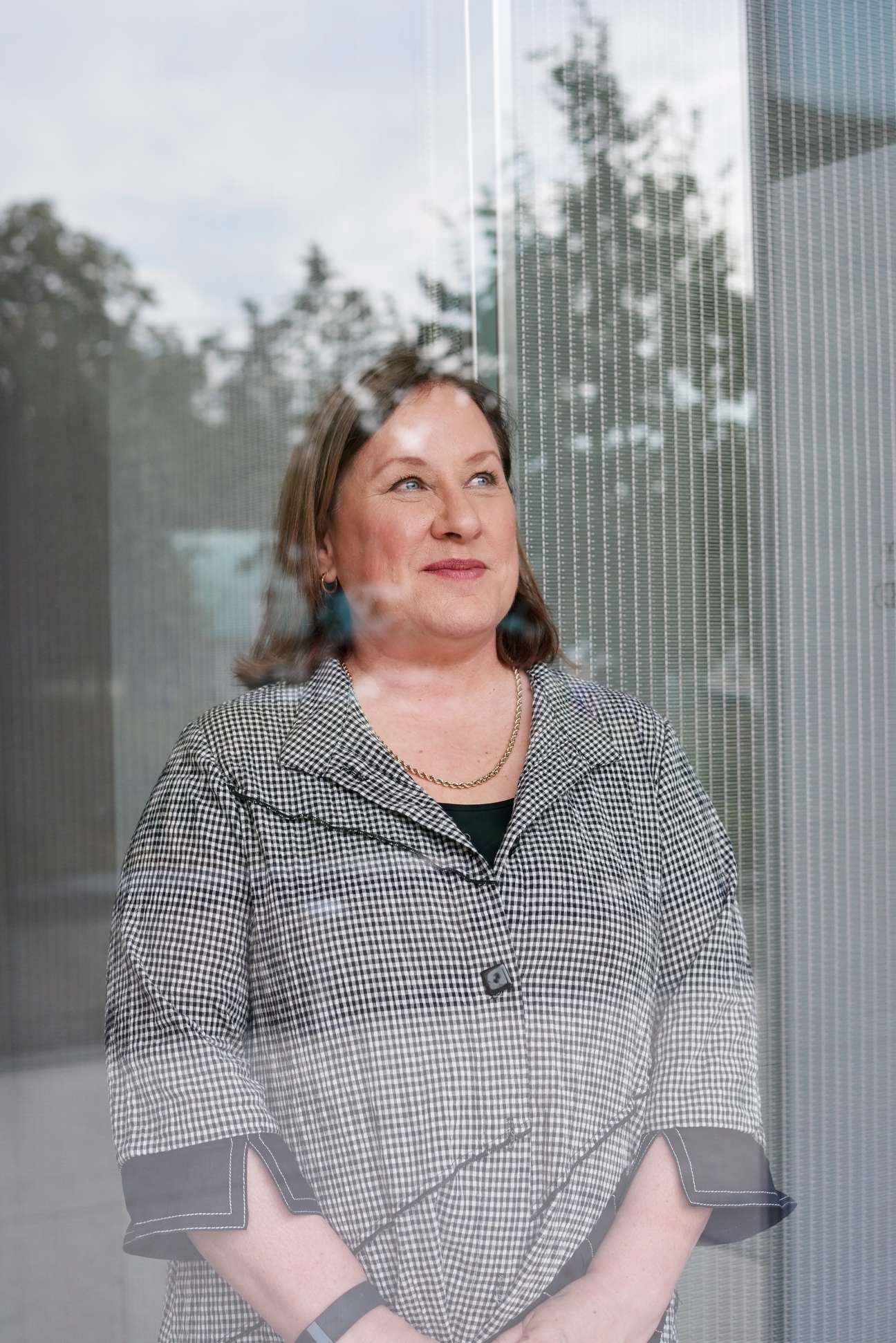 Mars CEO Ilse Treurnicht standing in front of a window with city buildings visible in the background.