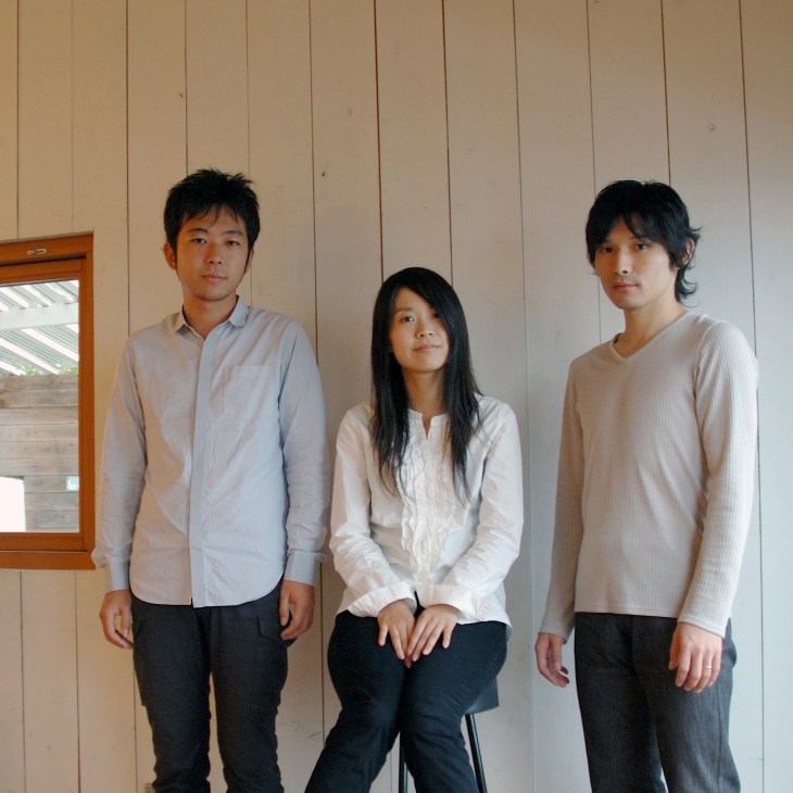 Portrait of three members of 3-1 design studio standing against a white panelled wall.