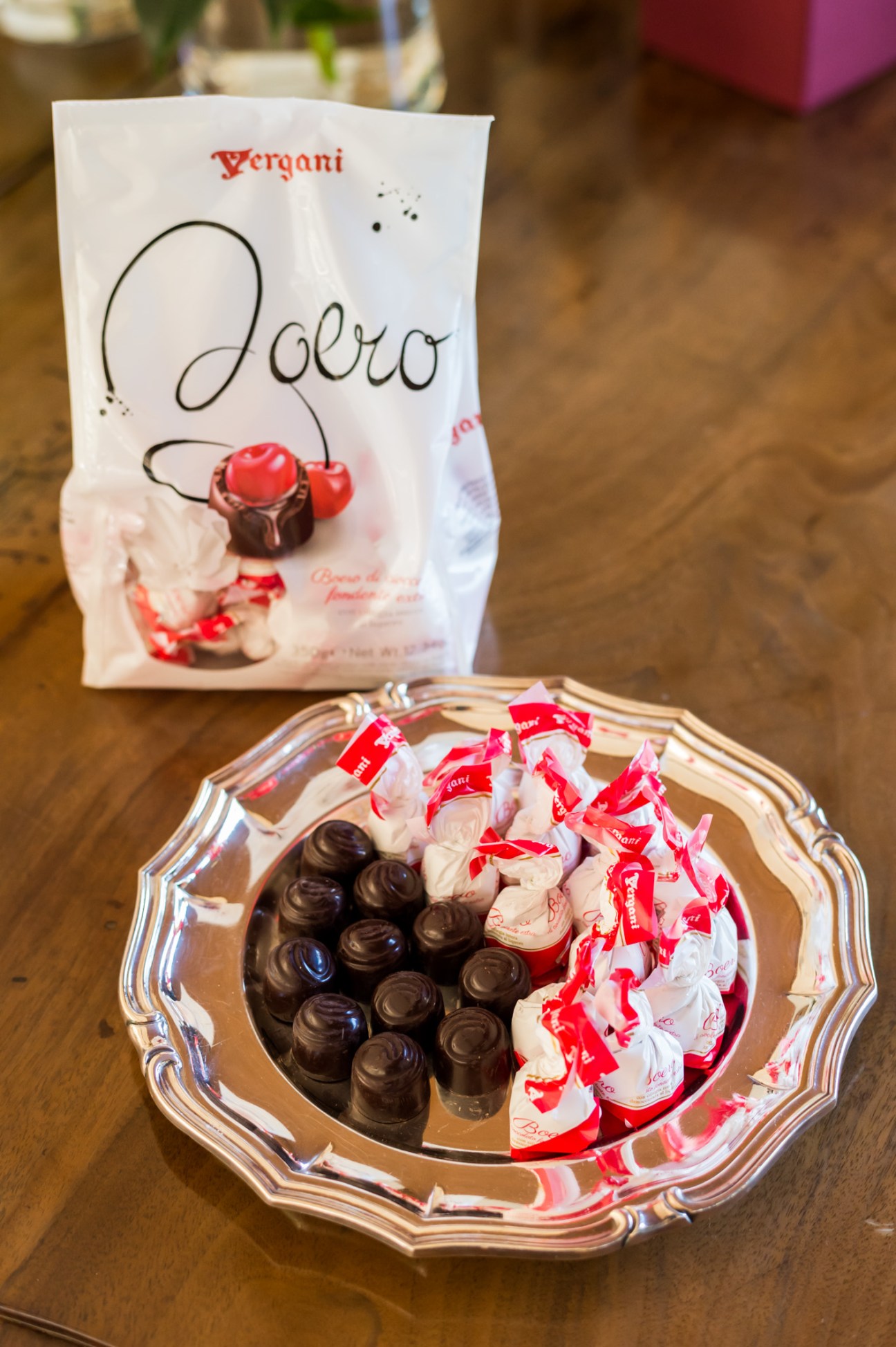 Vergani chocolate package and assorted chocolates on decorative plate