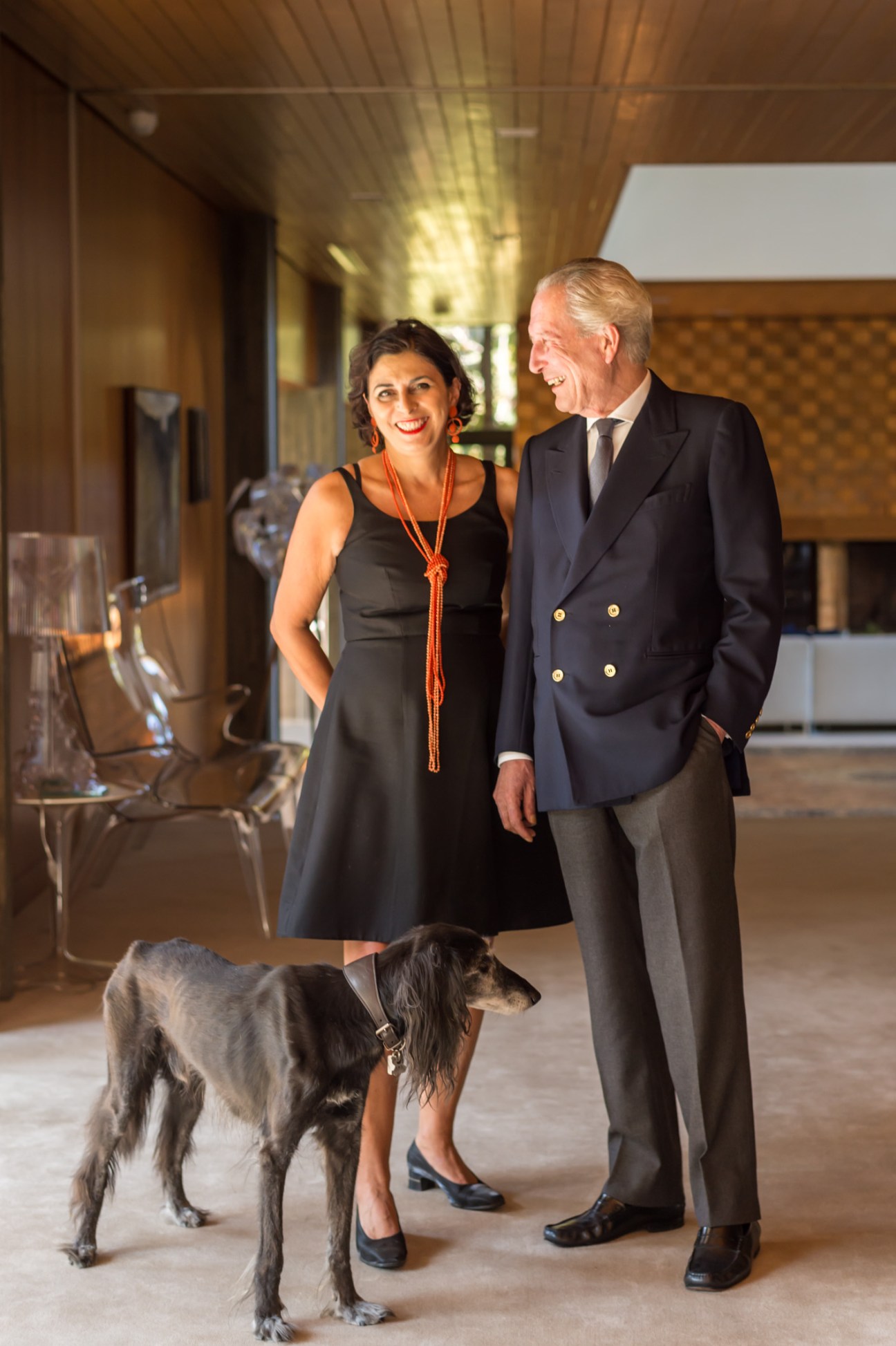Italian ambassador Domenico Giorgi, Rita Mannella and their dog Shaab in an elegant residence hallway.