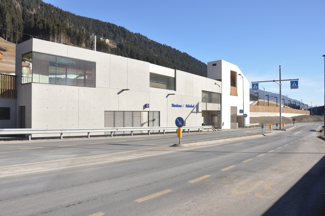 Versciaco-Monte Elmo Valley Station, a modern white building with large windows set against forested mountains in South Tyrol.