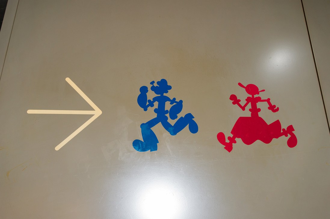 Colorful silhouette cutouts showing figures in dynamic poses, representing characters from Popeye and Olive Oyl cartoons.