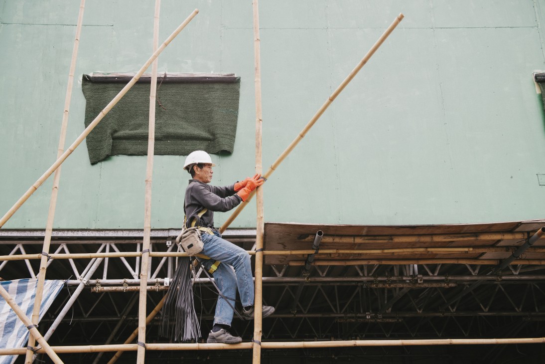 Master scaffolder Yu Wing Sung assembles bamboo scaffolding on a Hong Kong construction site.