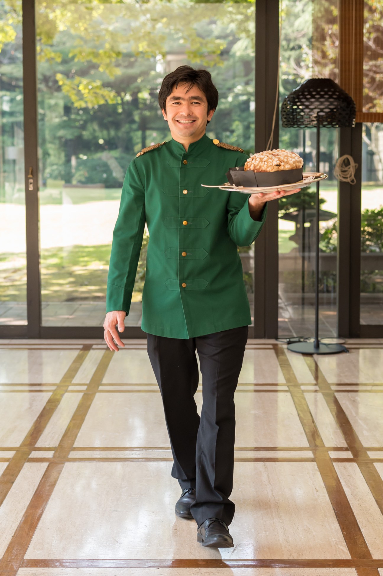 Chef holding a plate with panettone cake from Bulgari's Il Ristorante in Tokyo