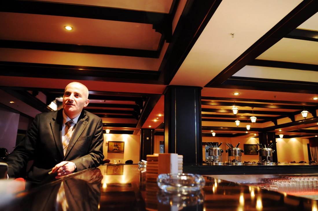 Saed Nijem, assistant food and beverage manager at the International Hotel, standing at the bar counter.