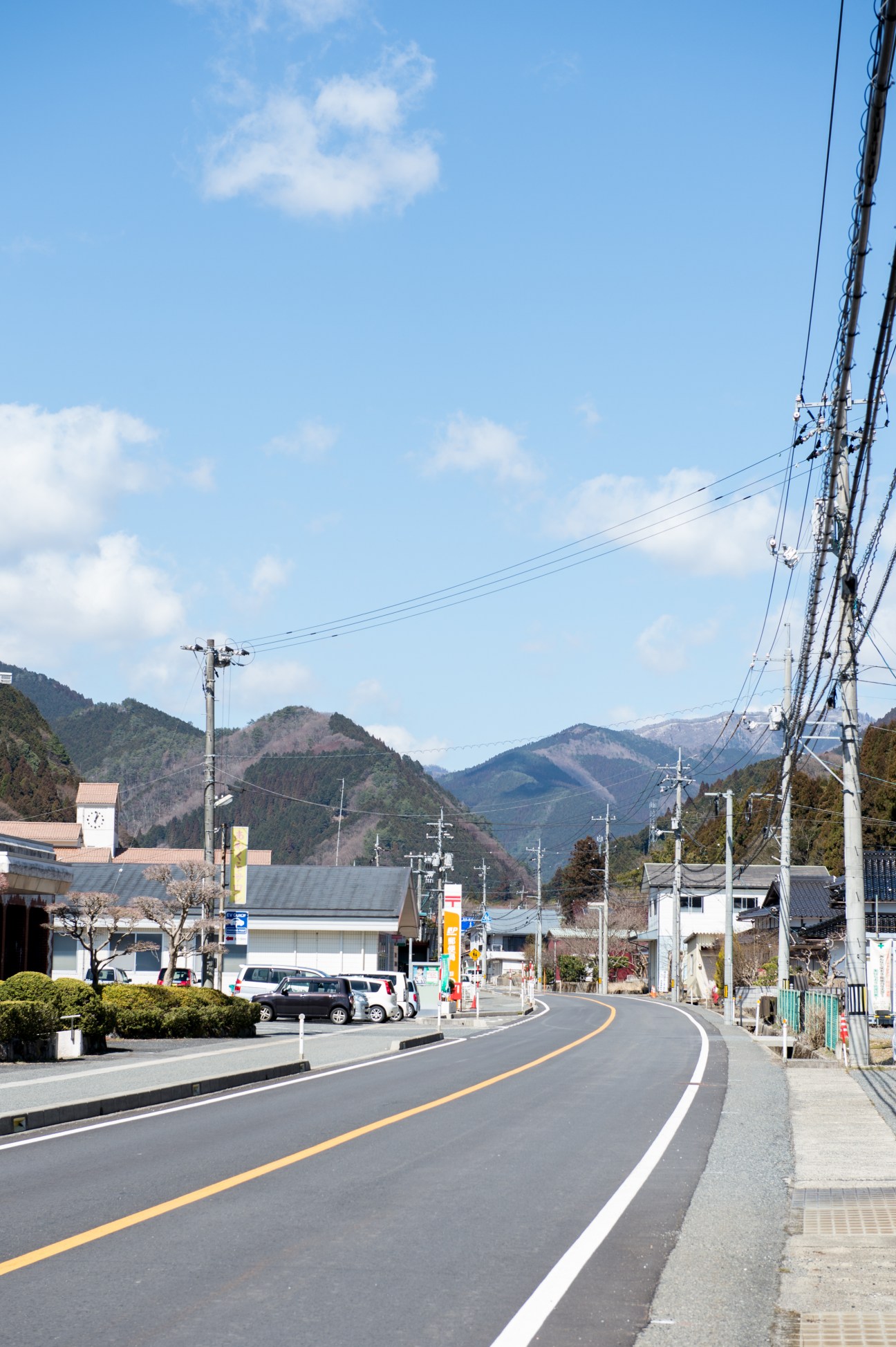 Main street of Nishi Awakura village with mountain views and local shops