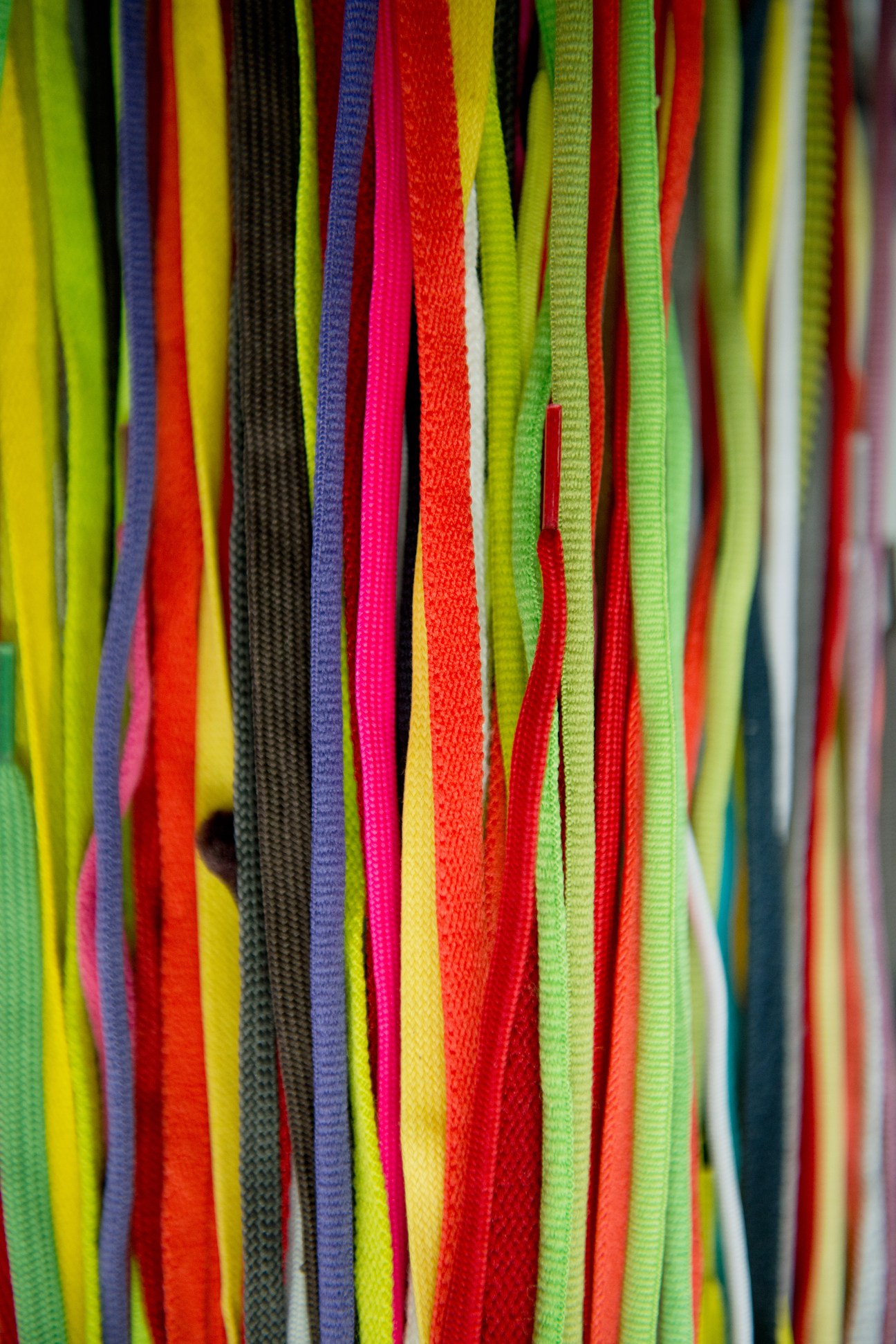 Colorful fabric swatches in yellow, red, green, blue and pink arranged vertically.
