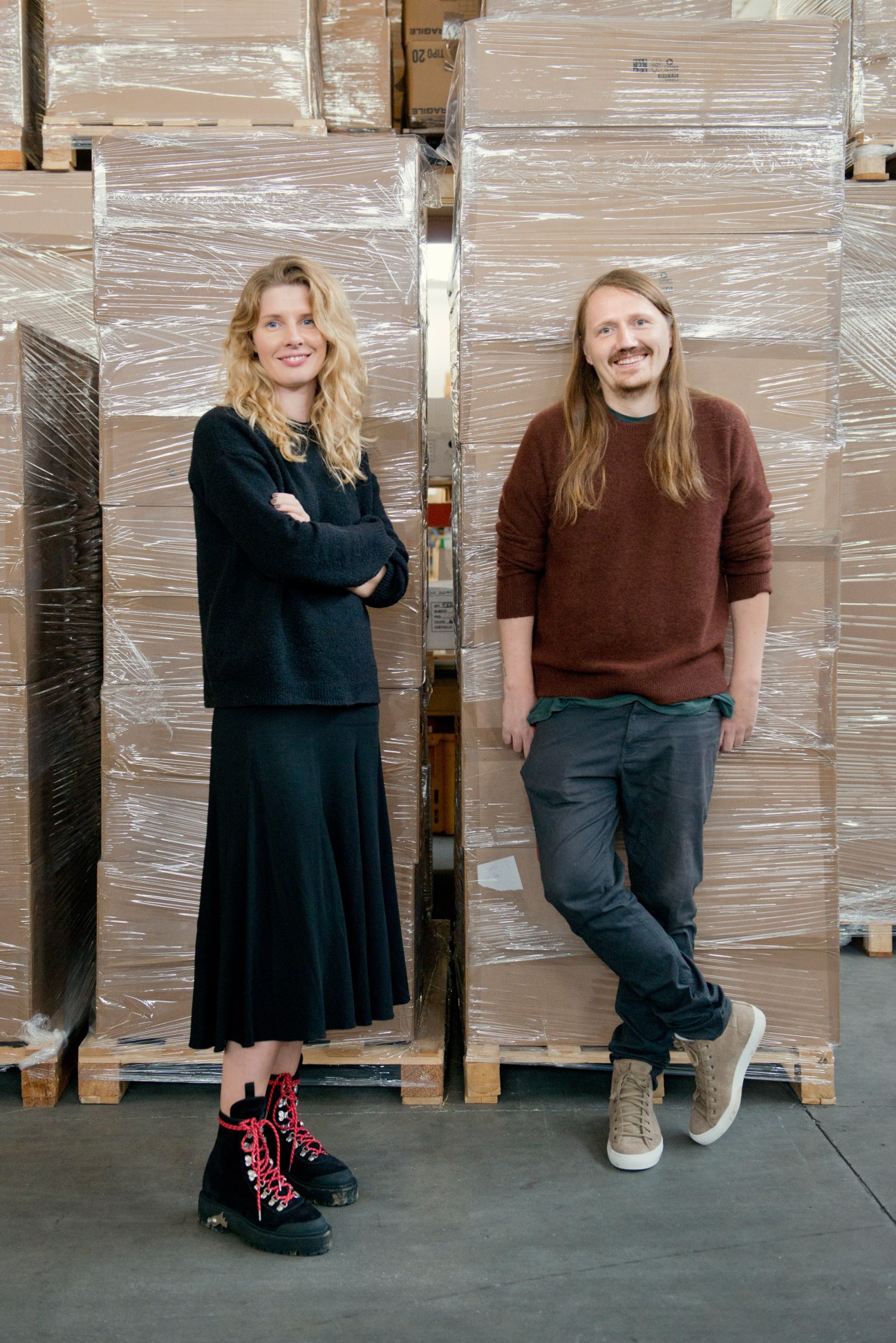 Karolina Hellström and Erlend Güettler Hansen stand in front of wrapped pallets at Diemme's factory warehouse.
