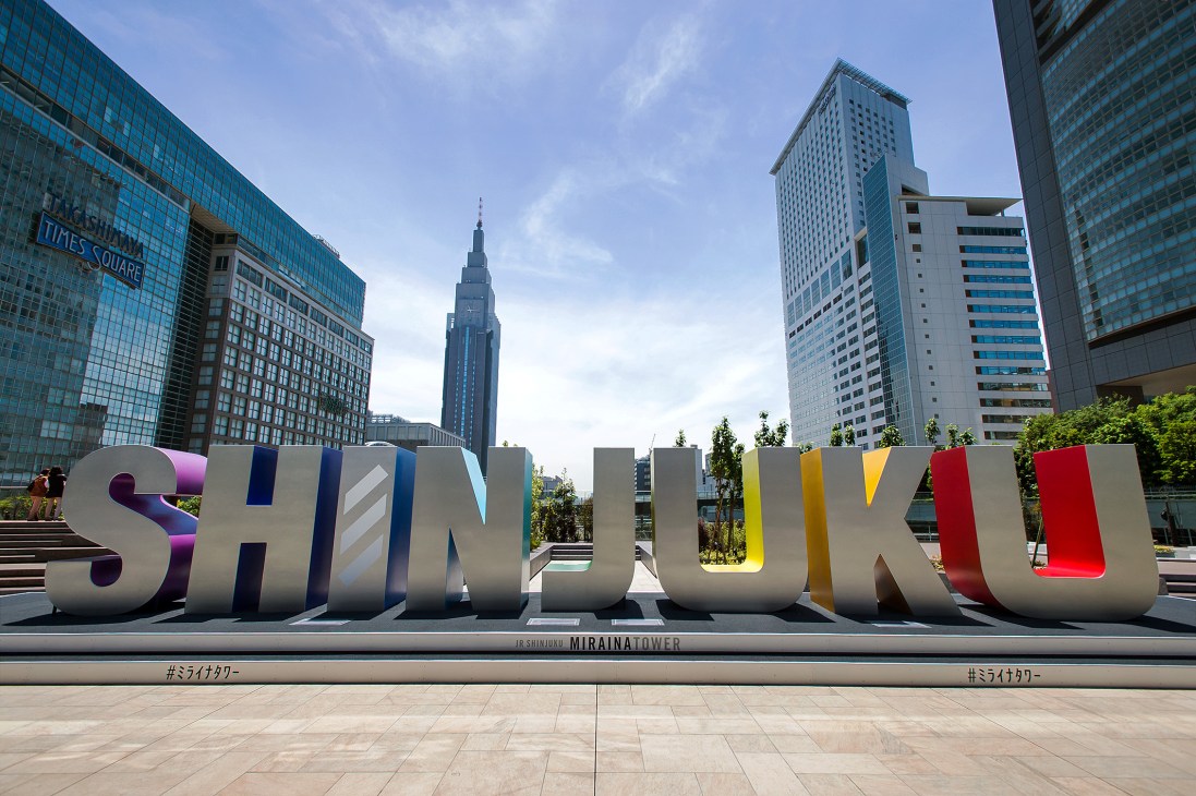 Colorful SHINJUKU signage at Miraina Tower with Tokyo skyline and skyscrapers behind