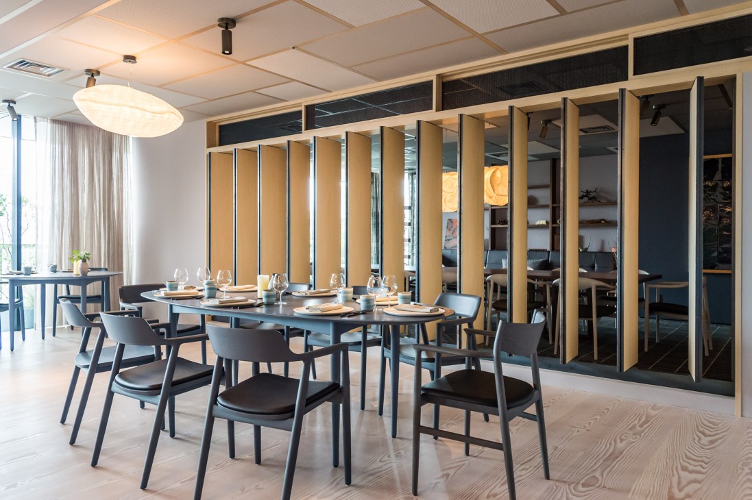 Restaurant dining room interior showing custom Jari table and designer chairs in modern setting