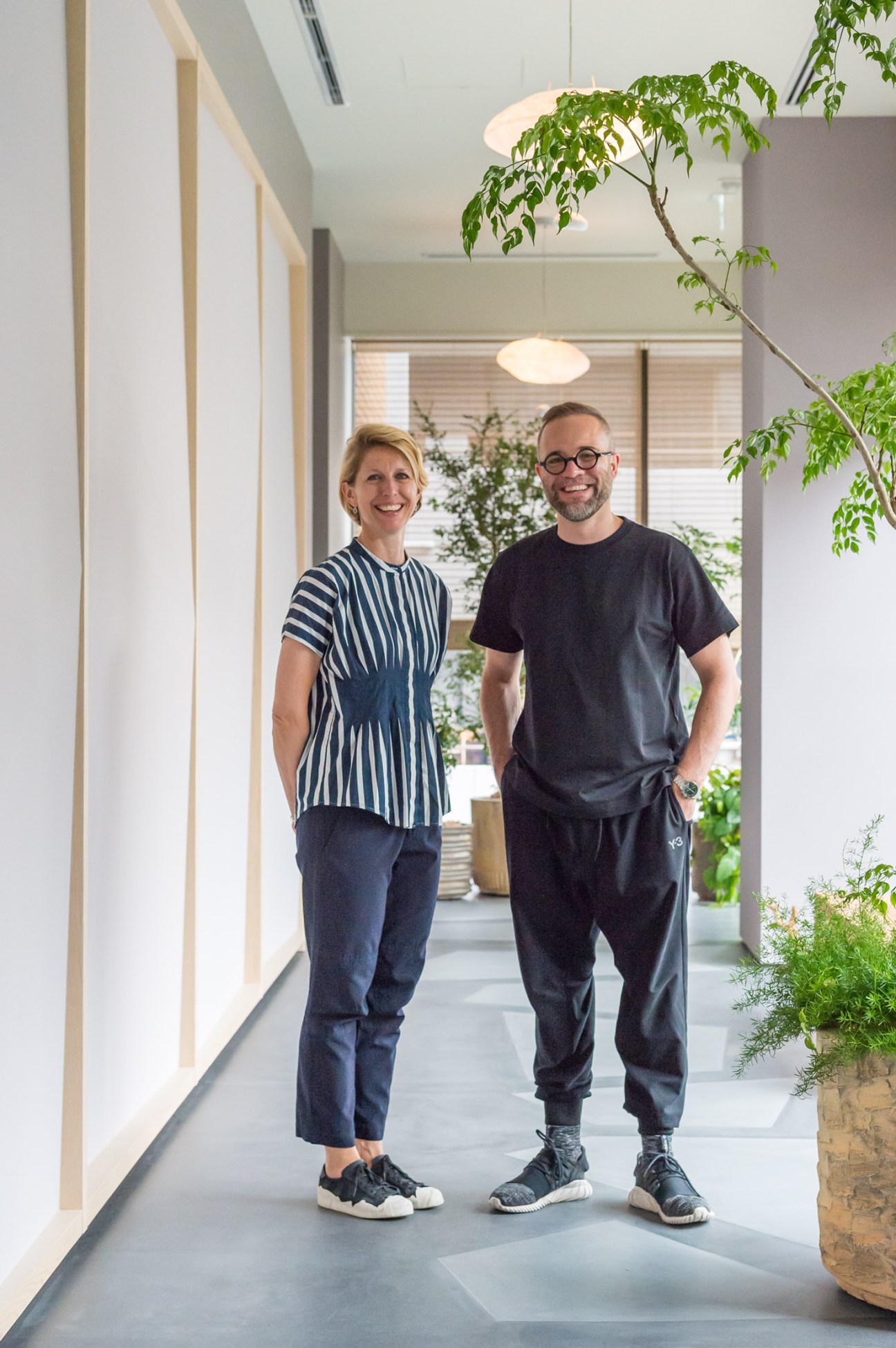 Portrait of two designers Anne-Marie Buemann and Thomas Lykke sitting together in restaurant setting